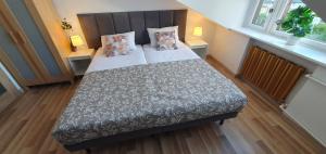 a bedroom with a bed with two pillows on it at Villa 31 in Sopot