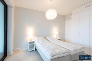 a white bedroom with a large bed and two lamps at A13 Premium Double room II floor in Hanko