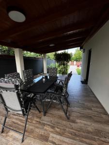 a black table and chairs on a patio at Laura Villa in Balatonlelle
