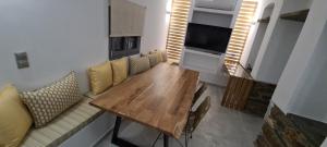 a living room with a wooden table and a couch at Aegean Sunset in Agios Sostis