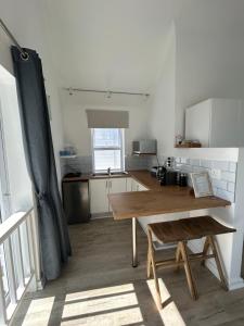 a kitchen with a wooden table in a room at Thesen View - exquisite views with bikes & canoe in Knysna