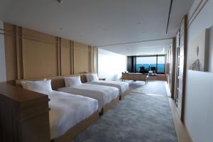 a hotel room with two beds and a window at Pearl Star Hotel ATAMI in Atami