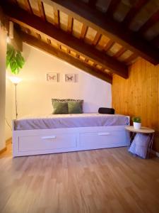 Una cama grande en una habitación con techo de madera. en Aire, en Valencia