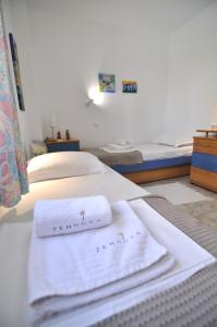 a bedroom with two towels on a bed at Zennova #43, Pirgadikia Sky & Sea Home in Pyrgadikia
