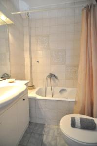 a bathroom with a tub and a toilet and a sink at Zennova #43, Pirgadikia Sky & Sea Home in Pyrgadikia +22 photos