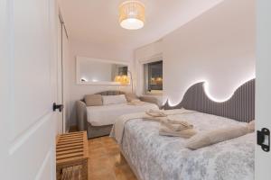 a bedroom with two beds and a hallway with two beds at Apt. Xaramiños Galitrips in Corcubión +29 photos