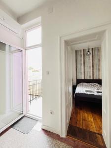 a bedroom with a bed and a large window at You will love it, in Vracar in Belgrade
