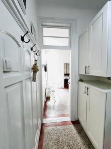 a hallway with a white door and a room at You will love it, in Vracar in Belgrade