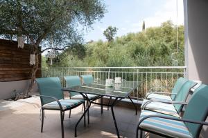 a table and chairs on a patio with a view at Sea Villa in Akrogiali