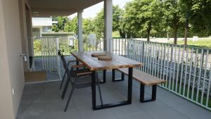 a wooden table and a bench on a balcony at Graz, Citytrip, Städtereise, Style-Apartment Loft 35 in Graz
