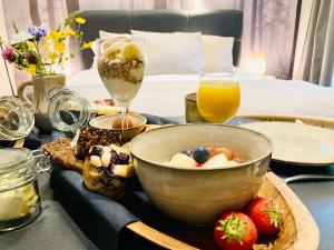 a table with a bowl of fruit and a tray of food at Het Roerhofje in Herkenbosch +9 photos