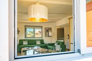 a living room with a green couch and a glass table at Residenza Echia in Naples
