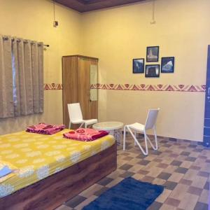 Postel nebo postele na pokoji v ubytování Aabancha Wada By Joy Suites