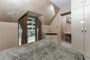 a bedroom with a large bed and a table at ALVA in Sandanski