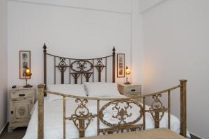 a bedroom with a metal bed with two night stands at Villa Areto in Kamares