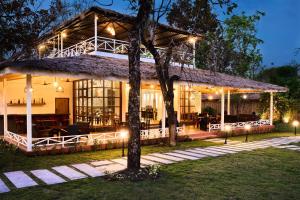 a house with a roof that is lit up at night at Saj In The Forest, Pench National Park in Seonī