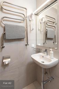 a bathroom with a sink and a mirror at Dandelion Apartments Stabu in Rīga