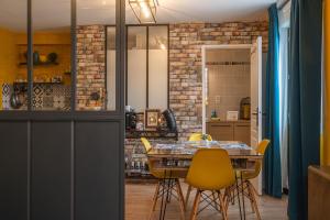 cocina y comedor con mesa y sillas amarillas en Studio 1 ATELIER VINCI en Amboise