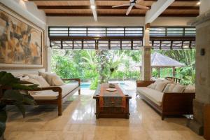 a living room with a couch and a coffee table at The Lavana Ziza Living And Villas Seminyak in Kerobokan