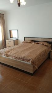 a bedroom with a large bed with a dresser and a mirror at Syunyats guest house in Halidzor