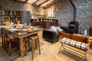 a kitchen with a table and a stove at R de Rural - Casa Rural de les Arnes in Encamp