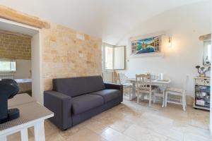 a living room with a couch and a table at Trulli San Pietro in Putignano