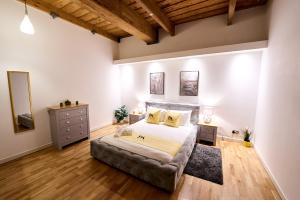 a bedroom with a large bed and wooden floors at Pluxa Citronella -2 floors Home of football location with Workspace in Manchester