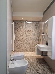a bathroom with a toilet and a sink at Cozy flat mins walk to Navigli and metro Porta Genova in Milan +10 photos