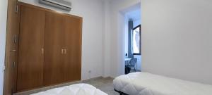 a bedroom with a bed and a cabinet and a desk at Albergue Rosa Molas in Arrabal de Jesús +49 photos
