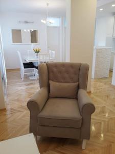 a living room with a chair and a table at Luxury Apartment Centar Mostar in Mostar