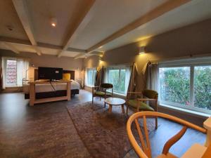 a bedroom with a bed and a living room at Art Hotel Harlingen in Harlingen