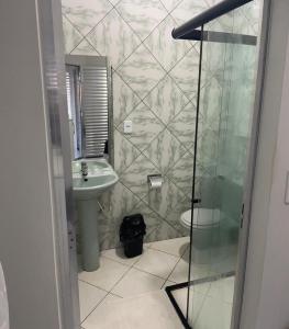a bathroom with a sink and a toilet and a shower at Hotel Shalom in Juazeiro do Norte