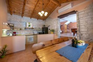 a kitchen with a wooden bench in a room at Villa Antoli by IstriaLux in Bašići