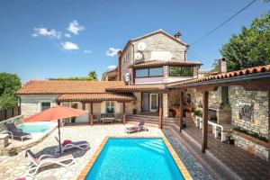a villa with a swimming pool and a house at Villa Antoli by IstriaLux in Bašići
