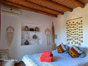een slaapkamer met een bed met kussens en planken bij maison de campagne avec piscine in Marrakesh