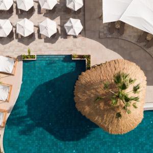 an overhead view of a swimming pool with umbrellas at Asterias Village in Hersonissos