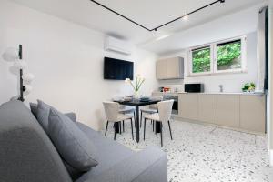 a living room with a couch and a table with chairs at Capri House in Capri +8 photos