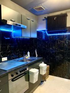 uma cozinha com lavatório e luzes azuis em Leben am Dortmunder U em Dortmund