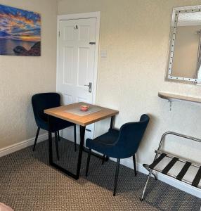 a table and two chairs in a room at Crossroads in Holyhead