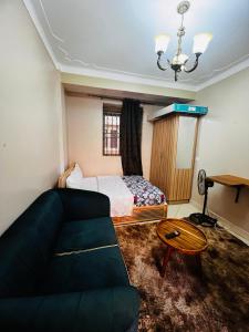 a living room with a couch and a bed at Cottage chill in Kampala
