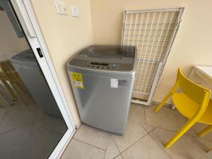 a refrigerator in a room with a table and a chair at JARDIN SECRET B1 in Las Terrenas