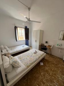 a bedroom with two beds and a desk in it at YOUTH HOSTEL - Central and Basic Drassanes in Barcelona