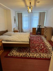 a bedroom with a large bed and a rug at Zur Baumwolle in Nuremberg