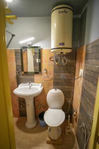 a bathroom with a toilet and a sink at Hotel Little Silver in Pahalgām +95 photos