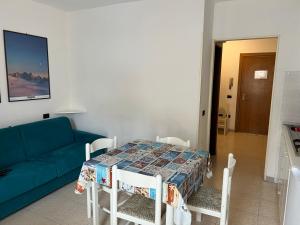 a living room with a table and a blue couch at Monolocale La torre in Rio Marina