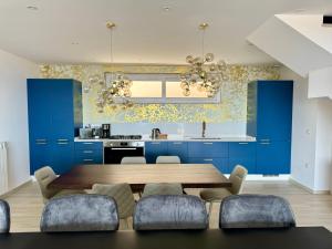 a kitchen with a wooden table and blue cabinets at Tropea Hills #5 in Santa Domenica