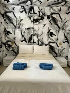 a bedroom with a bed with two blue pillows on it at Tropea Hills #5 in Santa Domenica +29 photos