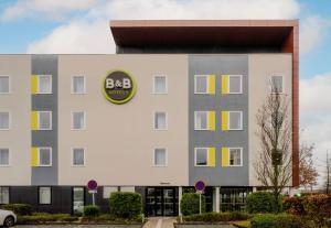 a large building with a bbc building at B&B HOTEL Arras in Arras