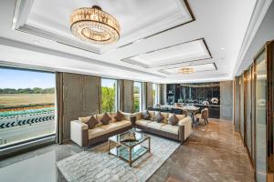 a living room with a couch and a table at Radisson Blu Hotel & Suites GRT Chennai in Chennai