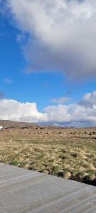 a path in a field with a blue sky at Cozy cottage, Mountain view in Selfoss